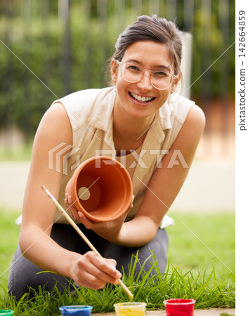Ceramic, pot and portrait of girl painting a craft container for plant in garden with creativity in hobby. Clay, art and artist with inspiration outdoor with paint brush, decoration or fun project Ceramic, pot and portrait of girl painting a craft container for plant in garden with creativity in hobby. Clay, art and artist with inspiration outdoor with paint brush, decoration or fun project 142664859