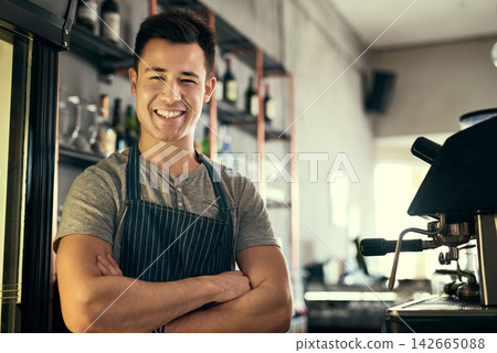 Happy, portrait and barista of cafe with pride in hospitality, service or waiter with arms crossed. Entrepreneur, smile and person in coffee shop, restaurant and professional server work with machine Happy, portrait and barista of cafe with pride in hospitality, service or waiter with arms crossed. Entrepreneur, smile and person in coffee shop, restaurant and professional server work with machine 142665088