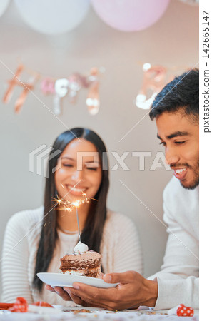 Birthday, smile and couple with cake and sparkler at party for celebration, surprise and present. Happy, flame and young man and woman with dessert food, sweet and gift for special event at apartment 142665147