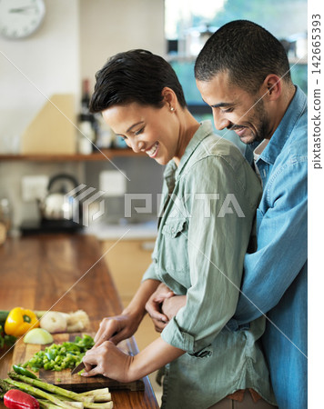 Vegan cooking, hug and couple in kitchen with smile for love, healthy food and bonding together for date. Vegetables, happy man and woman with knife for cutting, nutrition meal or preparation in home Vegan cooking, hug and couple in kitchen with smile for love, healthy food and bonding together for date. Vegetables, happy man and woman with knife for cutting, nutrition meal or preparation in home 142665393