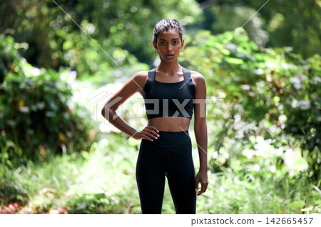 Portrait, active and young woman for fitness in outdoors with sportswear for exercise, training and workout for health. Confident, female person and athlete for wellness, strong and cardio routine 142665457