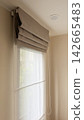 Luxury roman blinds with white sheer curtain on a condominium window 142665483