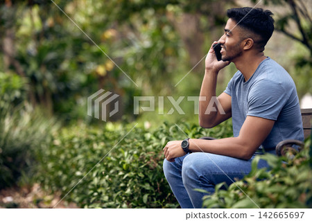 Phone call, man and college student in park, outdoor and talking with connection to contact and chat. University, education and person in campus with mobile, speaking and check for update in studying 142665697