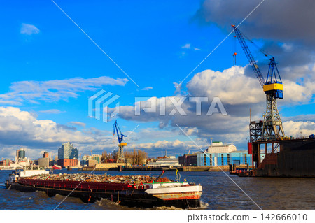 Industrial barge carrying scrap metal for recycling on the river Elbe in Hamburg, Germany Industrial barge carrying scrap metal for recycling on the river Elbe in Hamburg, Germany 142666010