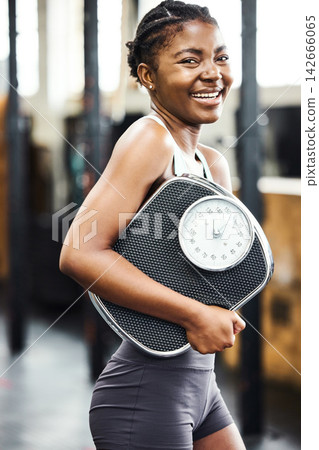 Exercise, portrait and scale with sports black woman in gym for training, weight loss or workout. Fitness, progress and smile with happy athlete in health club for physical improvement or wellness Exercise, portrait and scale with sports black woman in gym for training, weight loss or workout. Fitness, progress and smile with happy athlete in health club for physical improvement or wellness 142666065