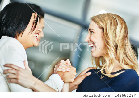Business, women and holding hands for solidarity in office with unity, teamwork and happy for partnership. Professional, employees and collaboration with laughing for funny motivation and equality Business, women and holding hands for solidarity in office with unity, teamwork and happy for partnership. Professional, employees and collaboration with laughing for funny motivation and equality 142666287
