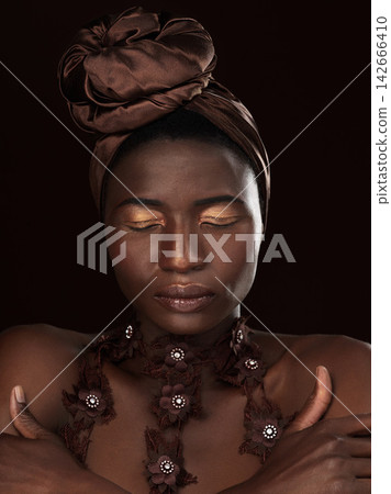 African woman, turban and makeup by dark background with elegance, pose and hands for traditional culture. Black queen, skin and cosmetics in studio with beauty, eyes closed and heritage from Nigeria African woman, turban and makeup by dark background with elegance, pose and hands for traditional culture. Black queen, skin and cosmetics in studio with beauty, eyes closed and heritage from Nigeria 142666410