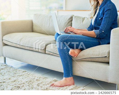 Woman, online and typing with laptop on sofa for email, survey review and work article or report for application. Girl, home and writing or planning task for project, living room and website for job. 142666575