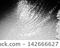 Dazzling diamond dust pours onto the pitch-black surface of the sea. 142666627