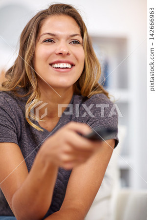 Home, smile or happy woman watching tv or movie on online subscription or enjoying fun videos or news. Remote control, break or excited female person streaming film to relax in lounge or living room Home, smile or happy woman watching tv or movie on online subscription or enjoying fun videos or news. Remote control, break or excited female person streaming film to relax in lounge or living room 142666963