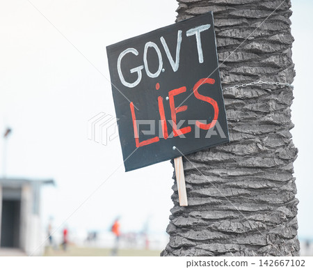 City, paper and protest banner with sign for government, corruption and political revolution. Tree, billboard and poster with statement in activism for human rights, propaganda or change in elections City, paper and protest banner with sign for government, corruption and political revolution. Tree, billboard and poster with statement in activism for human rights, propaganda or change in elections 142667102
