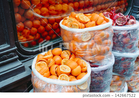 bags of squeezed oranges beside a shop window bags of squeezed oranges beside a shop window 142667522