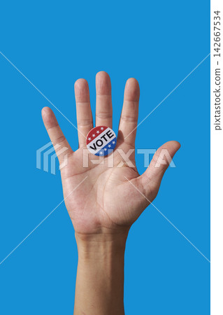 man displaying vote badge on open palm man displaying vote badge on open palm 142667534