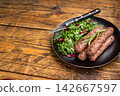 Balkan BBQ roast Cevapcici Sausage, roasted Cevapi from mince beef and pork meat. wooden background. top view 142667597