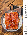 Unagi don or Japanese grilled eel rice in a bowl. wooden background. top view 142667600