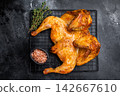 Roasted Spatchcock chicken with herbs and spices, poultry meat on steel rack. black background. top view 142667610