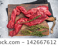 Uncooked Beef Skirt Steak, also name Machete steak, raw meat on cutting board. grey background. top view 142667612