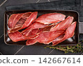 Dry cured and smoked serrano ham, pork meat. black background. top view 142667614