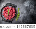 Diced Raw Boar meat, fresh Game Meat in a plate. black background. top view 142667635