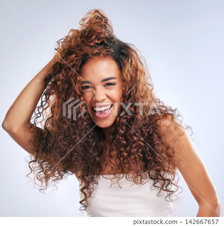 Happy, woman and healthy haircare in studio, portrait and natural curls, texture and growth with treatment for beauty. Smile, female person and cosmetics, shine or results on white background 142667657