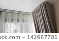 Luxury beige ripple fold curtains with white sheer on a curved track 142667781