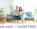 Middle couples relaxing in the living room Middle couples relaxing in the living room 142667893