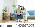Middle couples relaxing in the living room Middle couples relaxing in the living room 142667895
