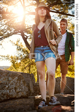 Travel, hiking and couple walking with trees, nature and adventure holiday in outdoor park. Trekking, man and woman on sustainable vacation together in woods with sunshine, rocks and date in forest Travel, hiking and couple walking with trees, nature and adventure holiday in outdoor park. Trekking, man and woman on sustainable vacation together in woods with sunshine, rocks and date in forest 142667938