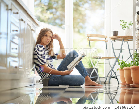 Woman, newspaper and portrait on kitchen floor for reading, global headlines or report with coffee. Person, press and print media with information for international news story in morning at apartment 142668104