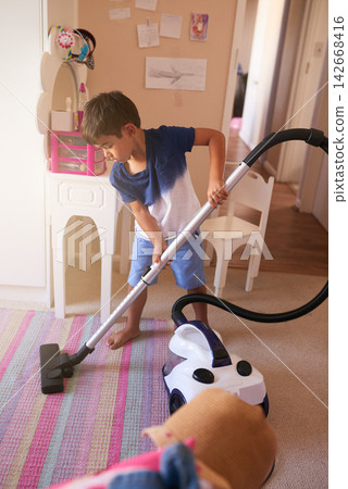 Child, carpet and vacuum for cleaning in bedroom, house and at home for child development and growth. Lens flare, youth and machine for responsible housekeeping, learning and chores for hygiene Child, carpet and vacuum for cleaning in bedroom, house and at home for child development and growth. Lens flare, youth and machine for responsible housekeeping, learning and chores for hygiene 142668416