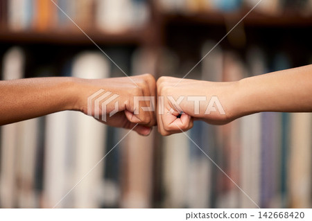 College, friends and hands with fist bump in library for partnership, support and help in education. People, teamwork and campus at university with emoji for motivation, trust and achievement in exam College, friends and hands with fist bump in library for partnership, support and help in education. People, teamwork and campus at university with emoji for motivation, trust and achievement in exam 142668420