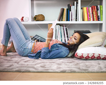 Black girl, relax and happy on floor with tablet for online entertainment, social media or streaming trending videos. Person, digital technology and internet for connectivity and scroll on website. Black girl, relax and happy on floor with tablet for online entertainment, social media or streaming trending videos. Person, digital technology and internet for connectivity and scroll on website. 142669205