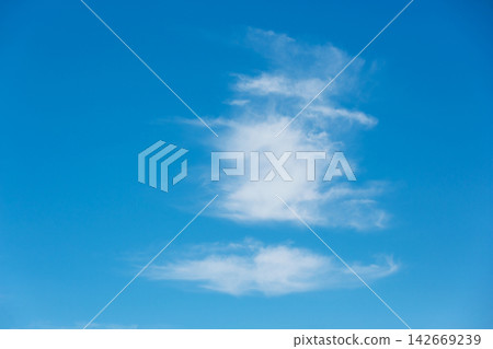 Soft wispy white cirrus clouds against vivid blue sky background Soft wispy white cirrus clouds against vivid blue sky background 142669239
