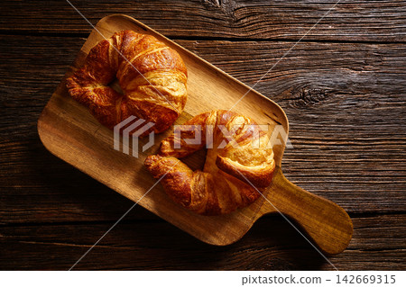 Croissants in wooden board Croissants in wooden board 142669315