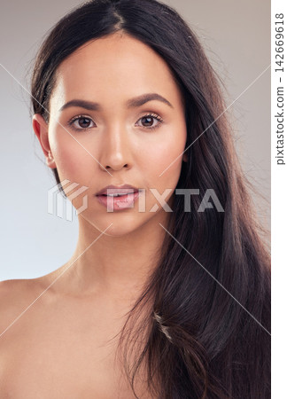 Woman, portrait and hair care in studio for health, wellness and skincare on gray background. Natural beauty, female person and treatment for sleek, shampoo and conditioner for keratin or growth Woman, portrait and hair care in studio for health, wellness and skincare on gray background. Natural beauty, female person and treatment for sleek, shampoo and conditioner for keratin or growth 142669618