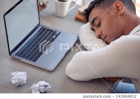 Office, sleeping and man at desk, laptop and tired with fatigue, overworked and exhausted. Person, employee and entrepreneur with computer, burnout and resting with power nap, low energy and peace Office, sleeping and man at desk, laptop and tired with fatigue, overworked and exhausted. Person, employee and entrepreneur with computer, burnout and resting with power nap, low energy and peace 142669652
