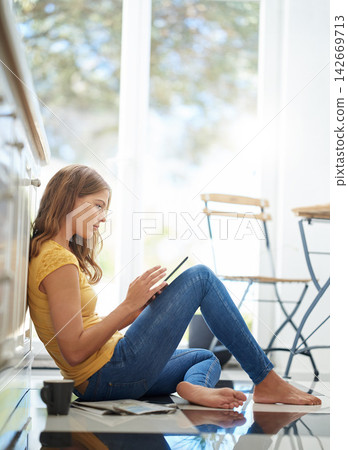 Woman, tablet and thinking on kitchen floor for typing, coffee or planning on application with schedule. Girl, writer and reading for creativity, notes or inspiration for story development in morning Woman, tablet and thinking on kitchen floor for typing, coffee or planning on application with schedule. Girl, writer and reading for creativity, notes or inspiration for story development in morning 142669713