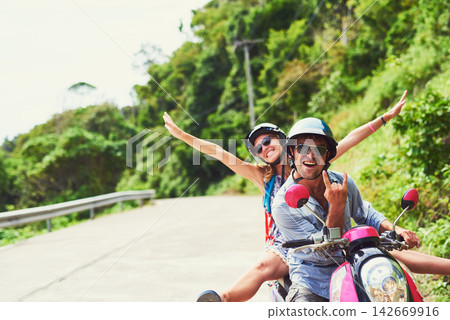 Couple, scooter and vacation with road trip, excited or happiness with transport, India or eco friendly. Joy, man or woman with helmet, holiday or explore with adventure, travel or journey with ebike Couple, scooter and vacation with road trip, excited or happiness with transport, India or eco friendly. Joy, man or woman with helmet, holiday or explore with adventure, travel or journey with ebike 142669916