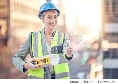Construction worker, woman and thumbs up for portrait with smile for vote, choice or good service. Mature architect, metro building and like sign with blueprint, property and real estate development Construction worker, woman and thumbs up for portrait with smile for vote, choice or good service. Mature architect, metro building and like sign with blueprint, property and real estate development 142669970