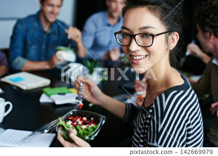 Meeting, food and portrait of woman with salad in office for team building lunch for collaboration. Discussion, smile and business female designer with colleagues eating healthy meal in workplace. 142669979