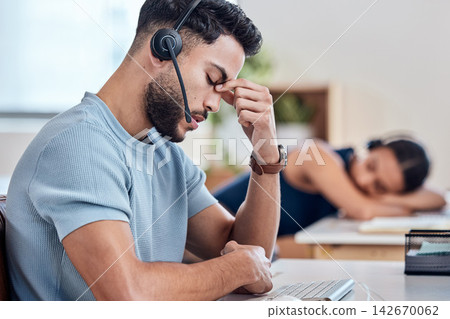 Stress, headset and man in call center for consulting, networking and communication in office. Male telemarketer, headache and customer support in workplace with burnout and anxiety for online job Stress, headset and man in call center for consulting, networking and communication in office. Male telemarketer, headache and customer support in workplace with burnout and anxiety for online job 142670062