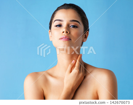 Cosmetics, skincare and portrait of woman in studio with natural beauty, confidence and luxury facial. Dermatology, face care routine and girl with glow, makeup and healthy skin on blue background. 142670073