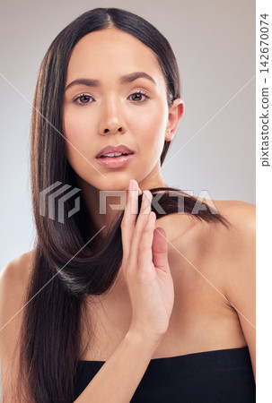 Portrait, salon and woman touch hair in studio for keratin treatment, shampoo or haircare on gray background. Hairstyle, beauty and hand of female model with texture for satisfaction, growth or shine 142670074