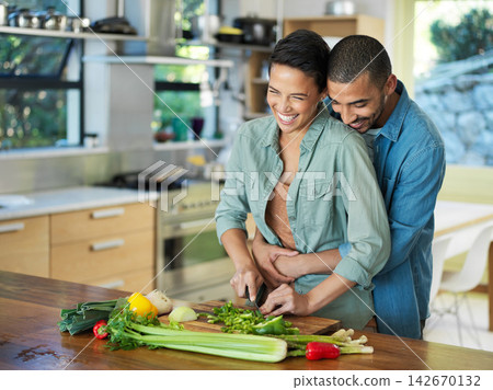 Cooking, vegetables and couple embrace in kitchen for love, healthy food and bonding together with date. Smile, happy man and woman with knife for cutting, nutrition meal or preparation in home Cooking, vegetables and couple embrace in kitchen for love, healthy food and bonding together with date. Smile, happy man and woman with knife for cutting, nutrition meal or preparation in home 142670132
