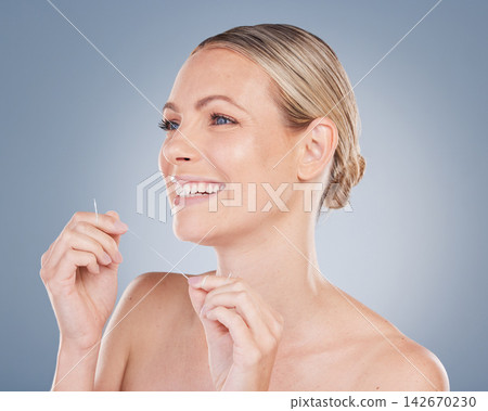 Dental, floss and woman with clean teeth in studio background and thinking of healthy gums. Person, smile and grooming plan or routine for hygiene and healthcare to prevent gingivitis or tooth decay 142670230