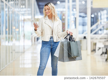 Shopping bag, phone or happy woman in mall texting online to search for bargain notification or social media. Retail, fashion and female customer on mobile app for chat, meme and website sale code Shopping bag, phone or happy woman in mall texting online to search for bargain notification or social media. Retail, fashion and female customer on mobile app for chat, meme and website sale code 142670507