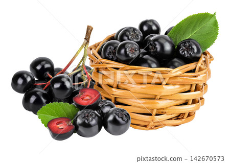 Chokeberry with leaf in a wicker basket isolated on white background. Black aronia. 142670573