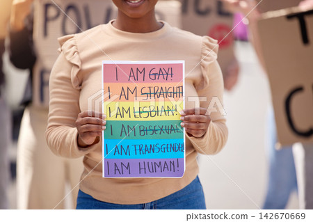 Protest, lgbtq and woman with poster, support and walking in street, paper or activism for human rights. social gathering, person or crowd with board, queer people or pride with community for freedom Protest, lgbtq and woman with poster, support and walking in street, paper or activism for human rights. social gathering, person or crowd with board, queer people or pride with community for freedom 142670669