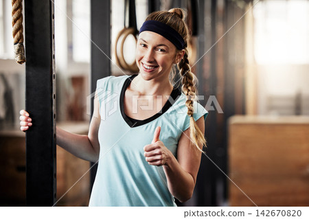 Woman, portrait and thumbs up with fitness in gym for sports, motivation and good workout in morning. Athlete, happy and smile with hand gesture for support, success and agreement in exercise Woman, portrait and thumbs up with fitness in gym for sports, motivation and good workout in morning. Athlete, happy and smile with hand gesture for support, success and agreement in exercise 142670820