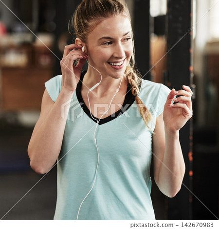 Woman, earphones and exercise music in gym or fitness podcast for performance, training or streaming. Female person, smile and online playlist for workout athlete or routine, challenge or internet Woman, earphones and exercise music in gym or fitness podcast for performance, training or streaming. Female person, smile and online playlist for workout athlete or routine, challenge or internet 142670983